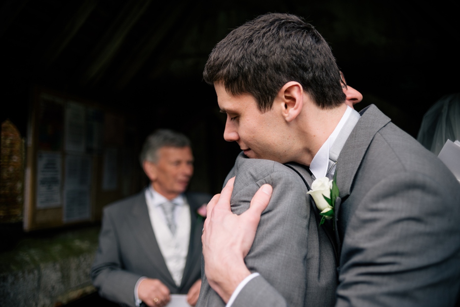 Groom embracing father