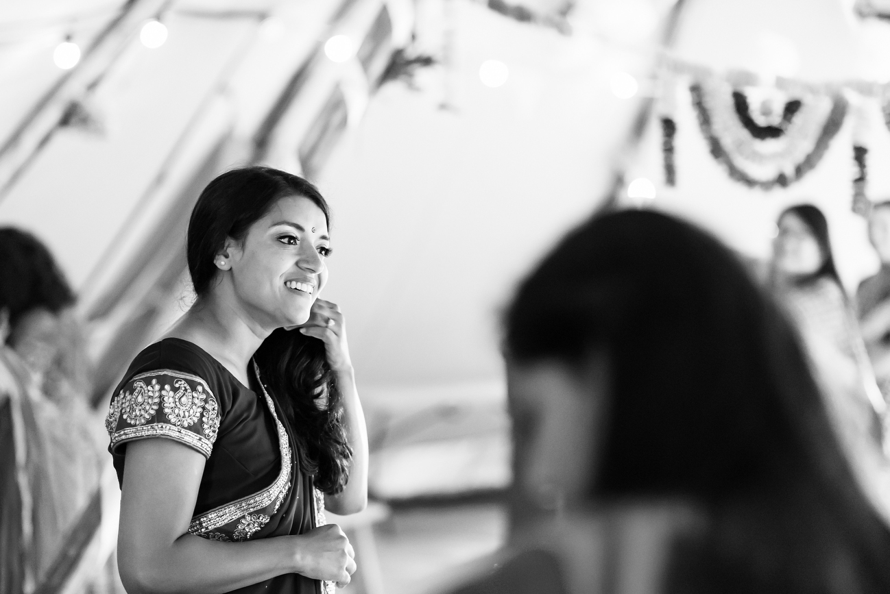black and white candid of bride smiling 